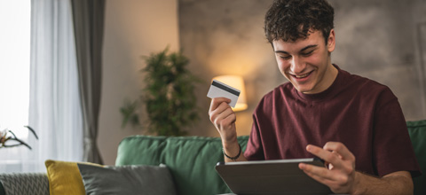 Teenage boy looking at his ipad.