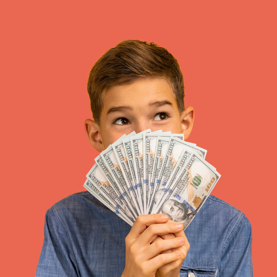 Young teen smiling behind a handful of cash.